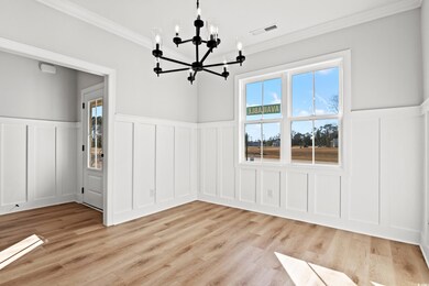 Spare room featuring light wood-type flooring, cro