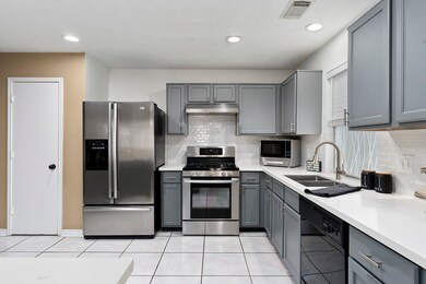 Remodeled kitchen with quartz counter tops and subway tile backslash.