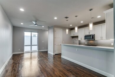 Kitchen featuring dark wood-type flooring, sink, d