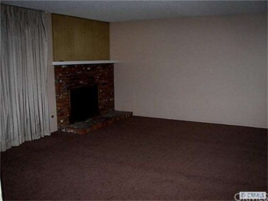 Living room with brick gas fireplace.