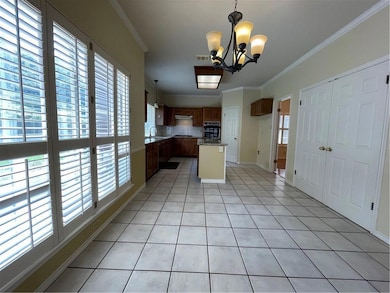Kitchen featuring a chandelier, light tile patter