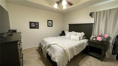 Bedroom featuring light colored carpet, baseboards