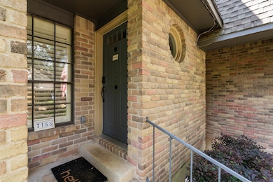 Doorway to property with brick siding