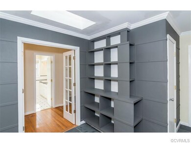 The entryway features a unique built-in shelving s