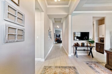 The extended foyer entrance with beautiful neutral tile floors, soft walls & high ceilings.