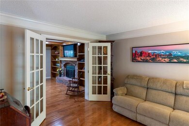 Charming living room with french doors leads into 