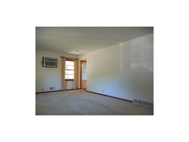 Living room with window a/c unit.