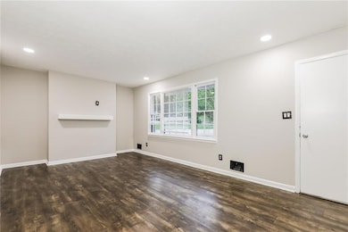 Unfurnished living room with dark wood-style floor