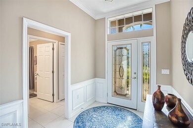 Entrance foyer featuring a wainscoted wall, orname