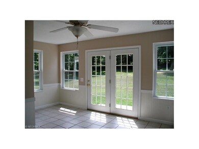 Sunroom with alot of natural light. French doors t