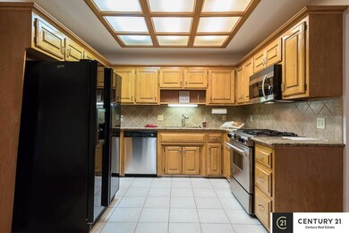 Granite counter tops, ceramic tile floor, stainless steel appliances and a gas Jenn-air range.