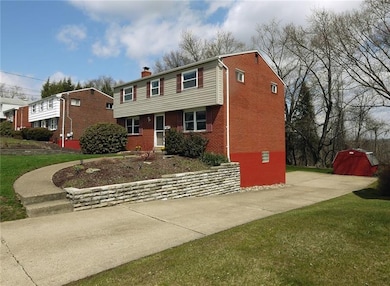 Level driveway leads to the integral garage and pl