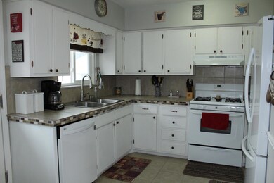 kitchen looks out fenced in back yard