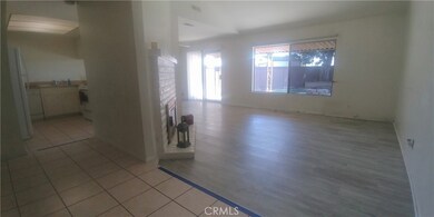 Tiled entry with small step down into living room, or kitchen to the left.  Laminate flooring in living room and dining room.
