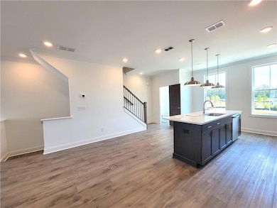 Kitchen featuring visible vents, wood finished flo