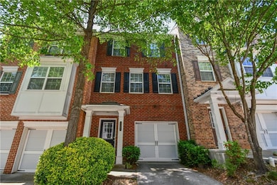 View of property with an attached garage, driveway