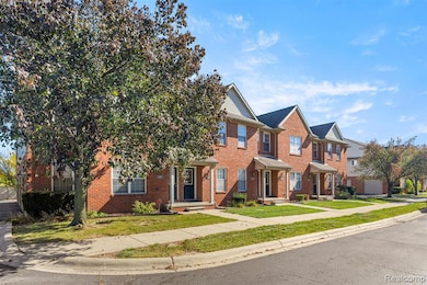 View of front facade with brick siding and a front lawn