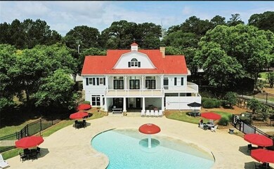 Rear view of house featuring a chimney, a patio ar