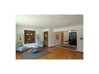 Living Room. Lovely untouched hardwood floors in g