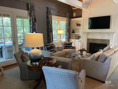 Living room featuring built in features and french doors