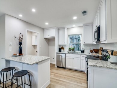 Kitchen featuring white cabinetry, a breakfast bar