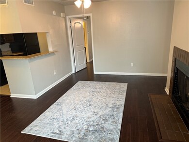 Living room with ceiling fan and dark hardwood / w