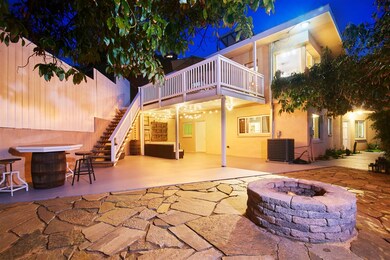 Large stone/concrete patio is partially covered by