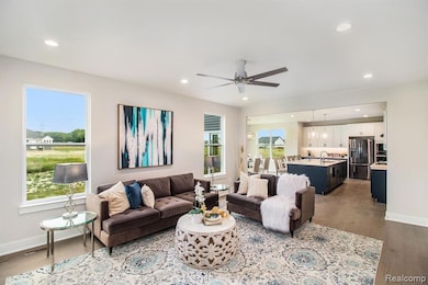 Living room with dark wood-style flooring, recessed lighting, and a ceiling fan