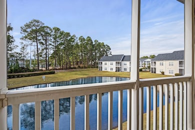 View of swimming pool with a water view and a yard