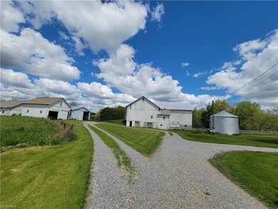 View of the outbuildings.  Note bank barn, grain t
