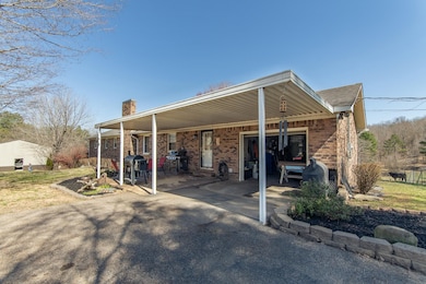 Exterior space with a garage, brick siding, drivew
