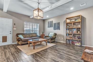 Living room featuring baseboards, dark luxury viny