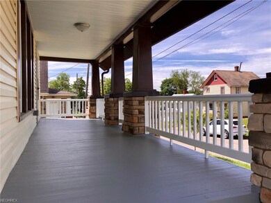 Front Porch with stone accents and vinyl railing.