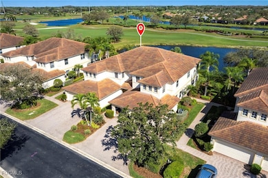 Aerial view of residential area with a large body of water and a golf club