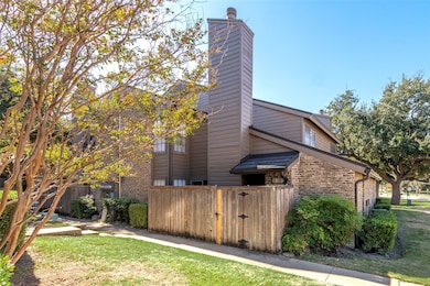 View of side of home with a chimney and stone siding
