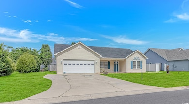 View of front of house with a garage, concrete dri
