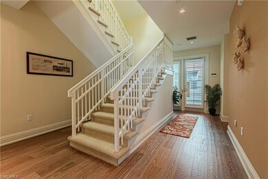 Foyer entrance featuring hardwood / wood-style flo