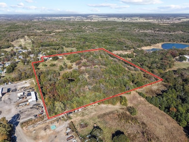 Aerial view of property's location with property parcel outlined and a nearby body of water