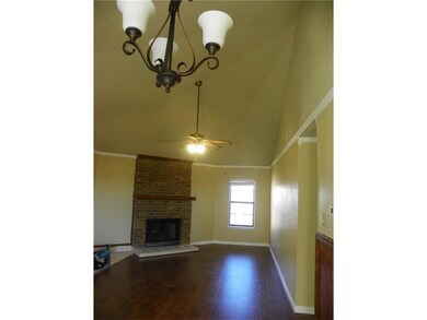 Unfurnished living room featuring ceiling fan with