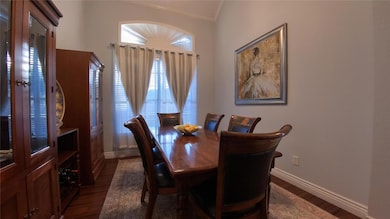 Dining room with lofted ceiling, dark hardwood / w