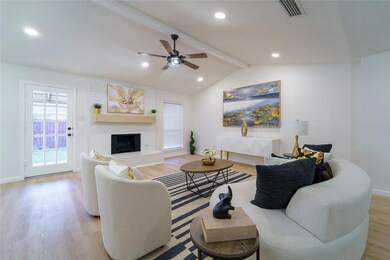 Living room with a brick fireplace, vaulted ceilin