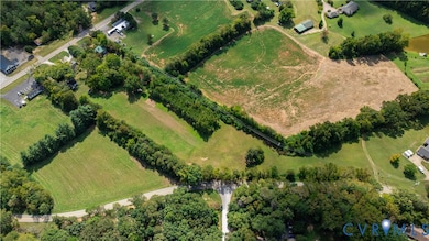 Aerial overview of property's location featuring rural landscape and abundant farmland