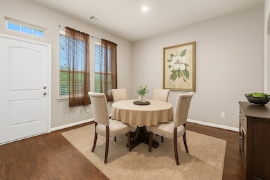 Dining room features soft lighting and large windo