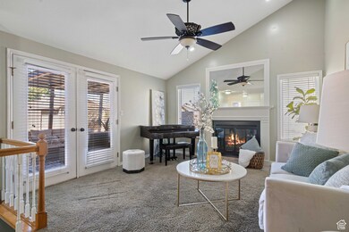 Living room featuring a  fireplace, french doors, and a vaulted ceiling