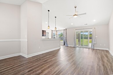 Unfurnished living room with ceiling fan, lofted c