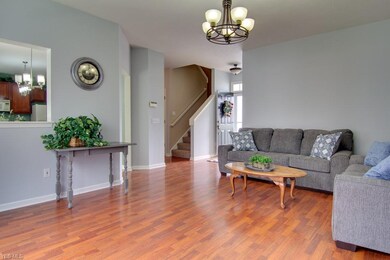 Large great room with newer lighting, laminate flo