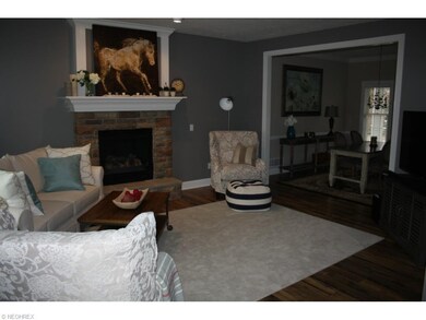 Wood floors and gas fireplace in Great room. Opens