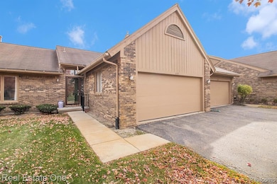 View of front of home featuring driveway, an attached garage