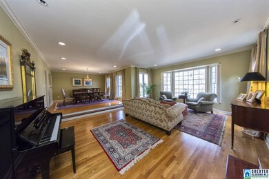 Spacious living room boasts a bay window overlooki