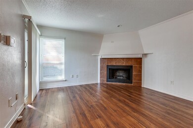 Unfurnished living room featuring a textured ceili
